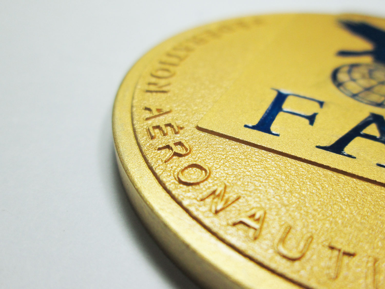64mm stamped copper coin lacquered in gold color with blue resin.